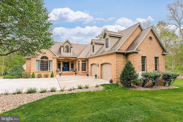 view of front of house with brick siding, a front lawn, roof with shingles, a garage, and driveway