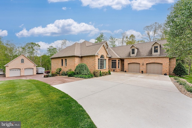 view of front of home featuring brick siding, driveway, a shingled roof, and a front lawn