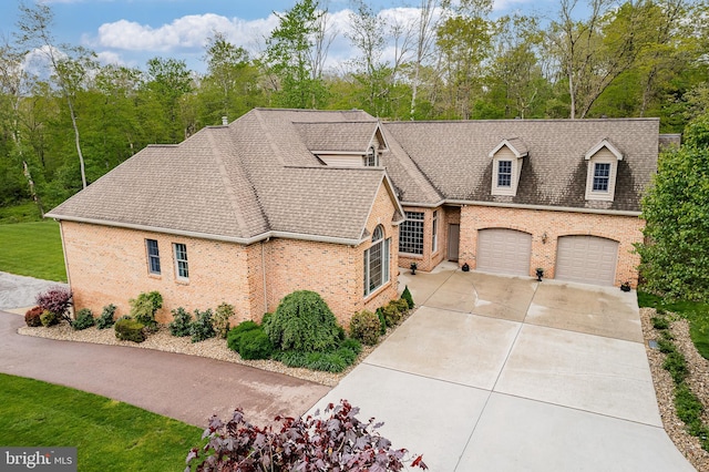 view of front of home with brick siding, driveway, an attached garage, and roof with shingles