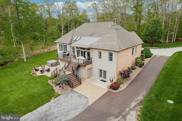 view of front of house featuring a patio area, stairway, a front lawn, and a deck