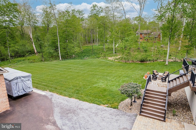 view of yard with a wooden deck and stairs