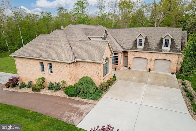 view of front of property featuring a garage, brick siding, concrete driveway, and a shingled roof