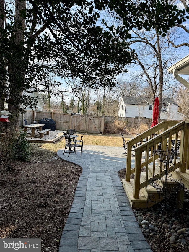 view of community featuring a patio area, fence, and a gate