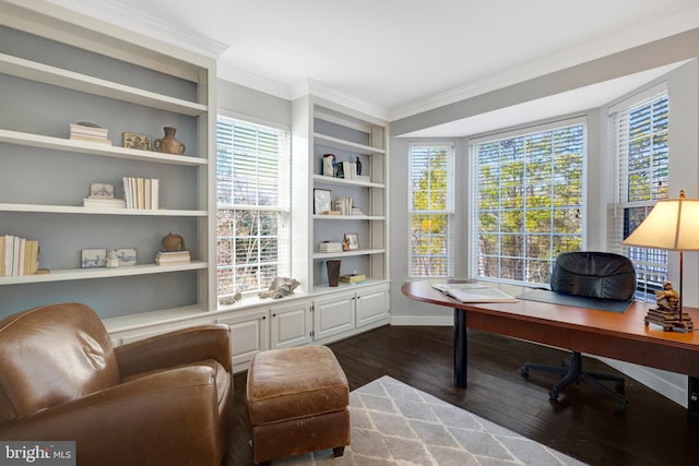 office with built in features, dark wood-style floors, ornamental molding, and a wealth of natural light