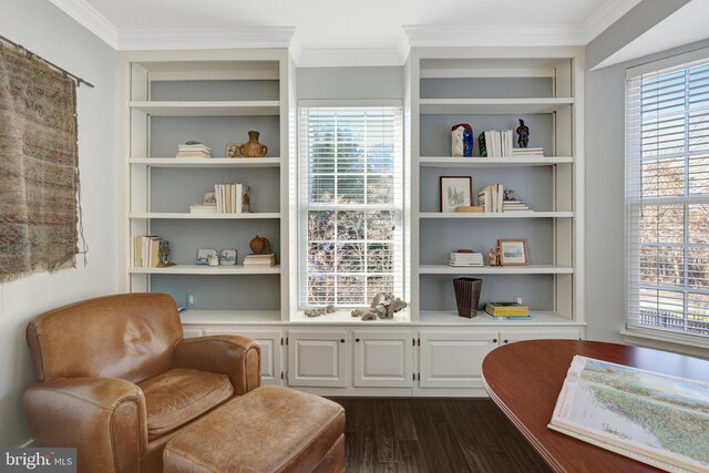 sitting room with dark wood-style floors, ornamental molding, a wealth of natural light, and built in features