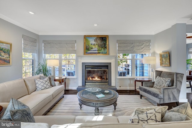 living room with plenty of natural light, crown molding, and wood finished floors