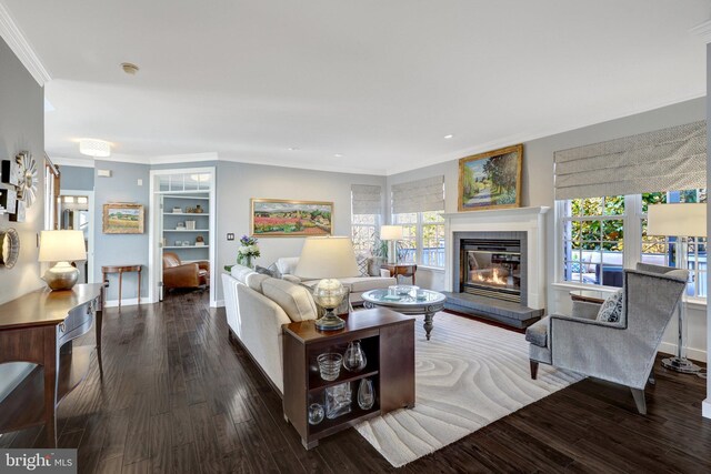 living room featuring a healthy amount of sunlight, crown molding, and wood finished floors