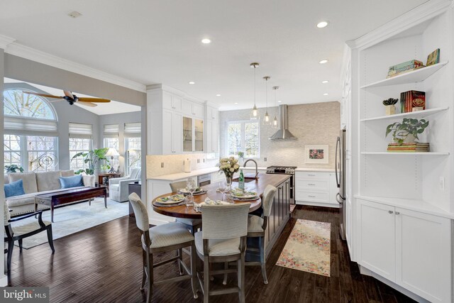 dining room featuring ceiling fan, ornamental molding, dark wood finished floors, and recessed lighting