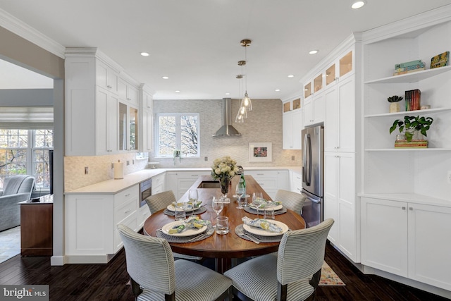 dining room featuring dark wood-type flooring, recessed lighting, and crown molding