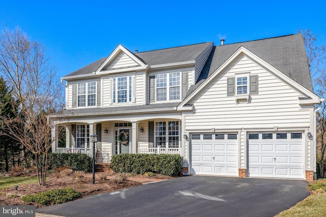 view of front of home with driveway and a porch