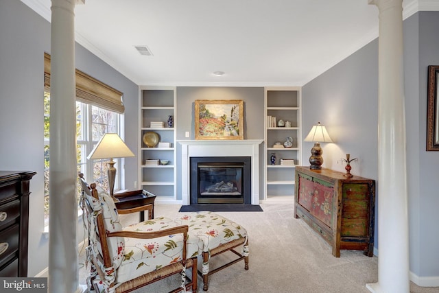 living area with carpet floors, visible vents, decorative columns, and built in shelves