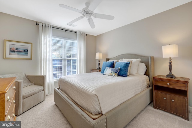 bedroom with light carpet, visible vents, and a ceiling fan