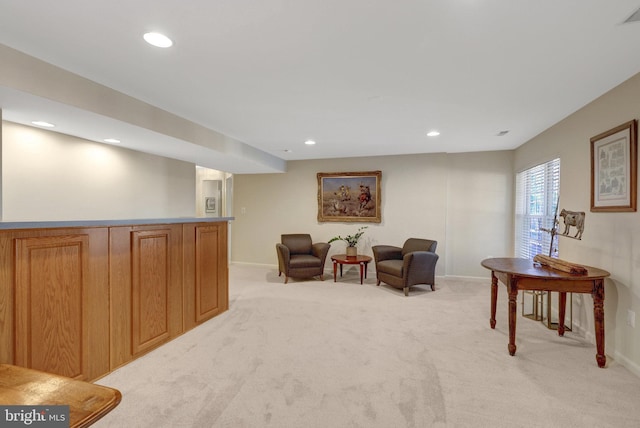 living area with baseboards, recessed lighting, visible vents, and light colored carpet