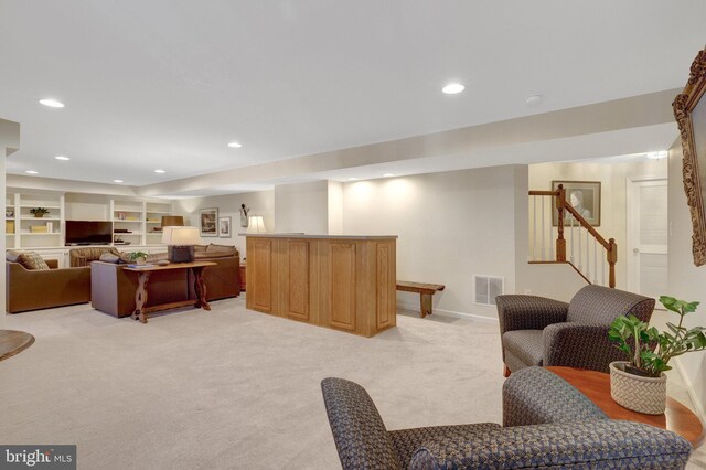 living area featuring stairway, recessed lighting, visible vents, and light colored carpet