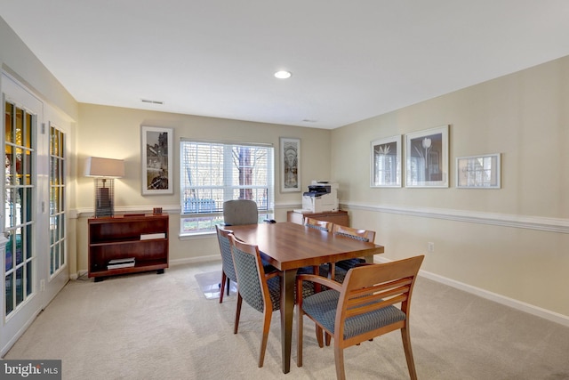 dining space featuring light carpet, recessed lighting, visible vents, and baseboards