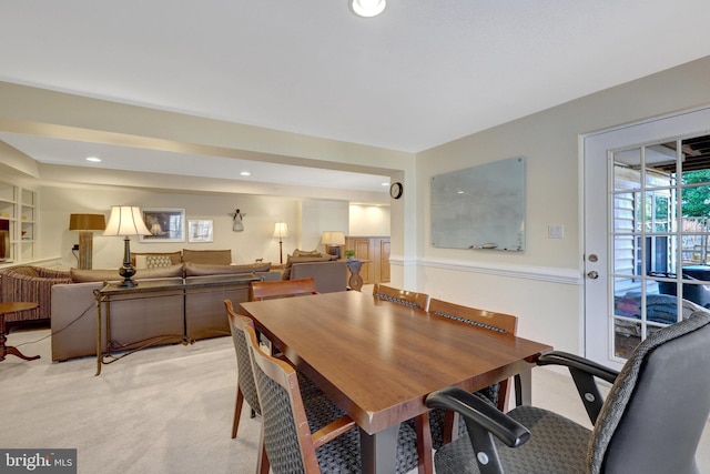 dining space featuring light carpet and recessed lighting