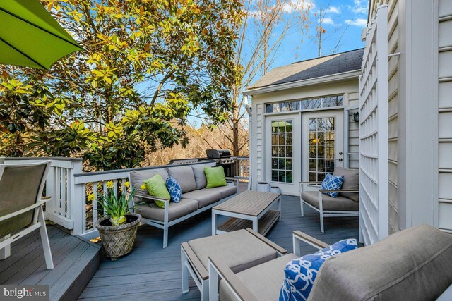 wooden terrace featuring area for grilling and an outdoor hangout area