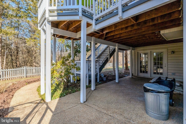 view of patio / terrace with french doors, fence, and stairway