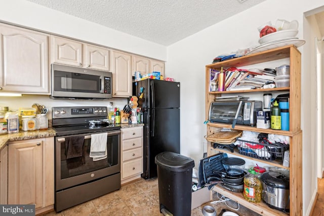 kitchen featuring appliances with stainless steel finishes, a textured ceiling, and light stone countertops