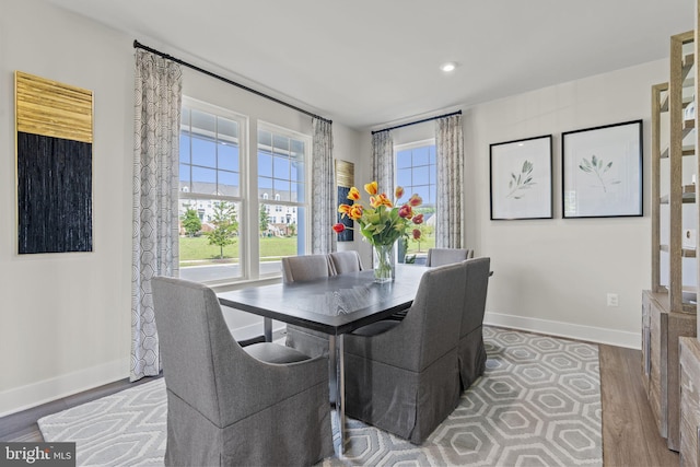 dining room with recessed lighting, baseboards, and wood finished floors