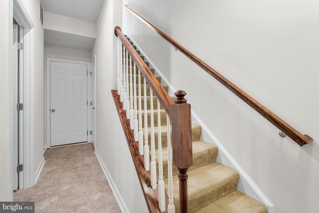 stairway featuring baseboards