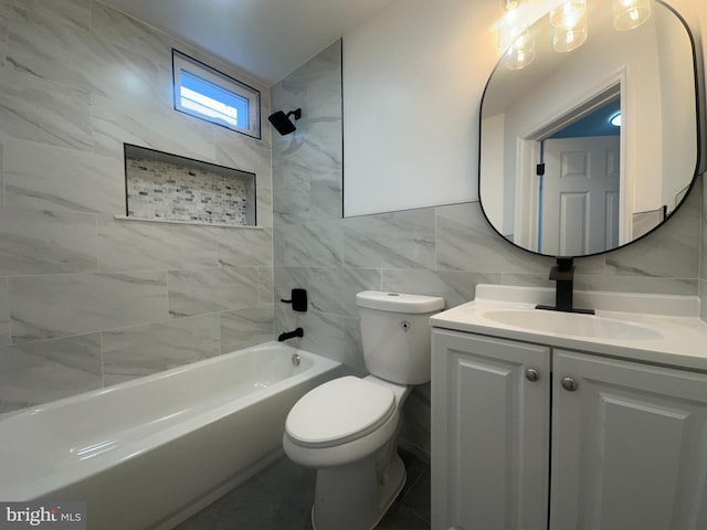 full bath with toilet, shower / bathing tub combination, tile walls, and vanity