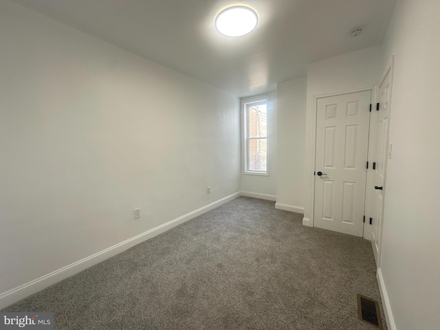 unfurnished bedroom featuring baseboards, visible vents, and carpet flooring