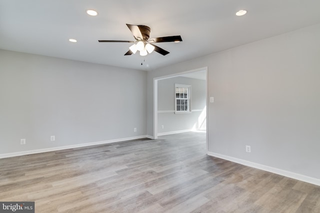 empty room with baseboards, ceiling fan, wood finished floors, and recessed lighting