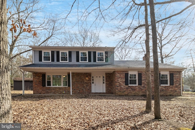 traditional-style house with covered porch and brick siding