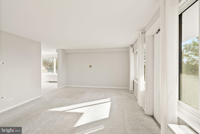 unfurnished bedroom with baseboards and light colored carpet