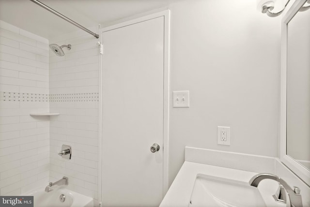 full bathroom with a sink and washtub / shower combination