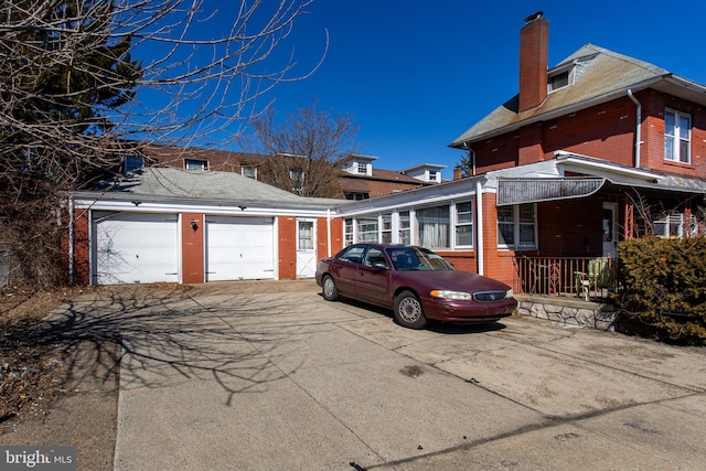 view of side of home with brick siding and a chimney