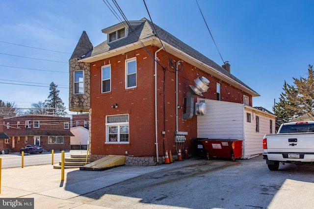 view of property exterior with brick siding