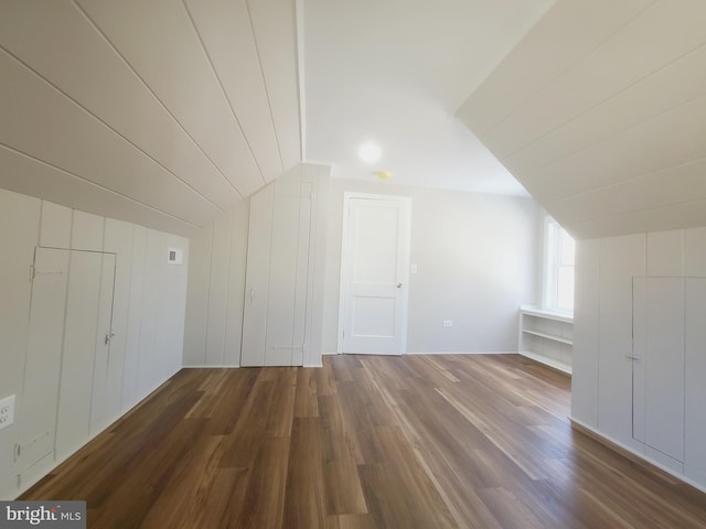 additional living space with vaulted ceiling and wood finished floors