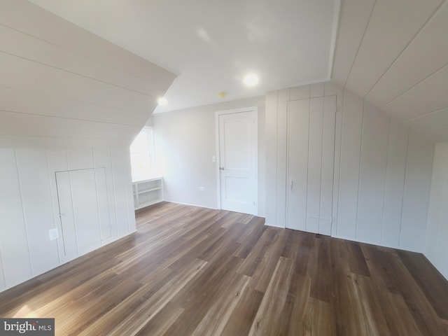 bonus room with lofted ceiling and wood finished floors