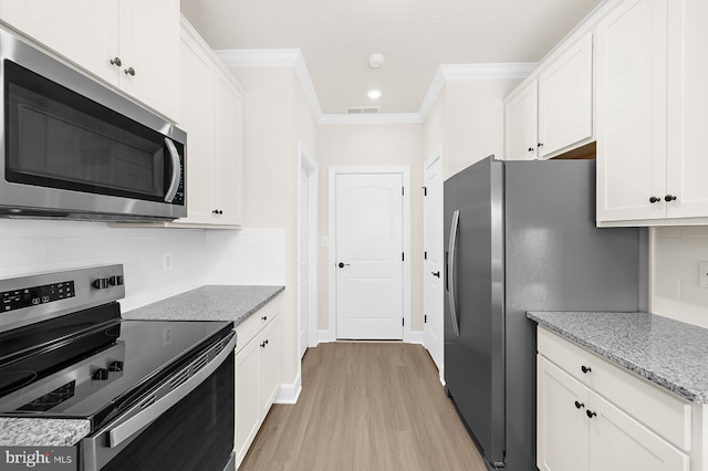 kitchen with white cabinetry, appliances with stainless steel finishes, and crown molding