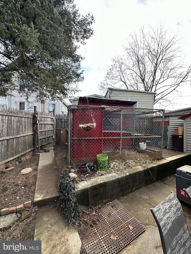 back of house with an outbuilding and fence