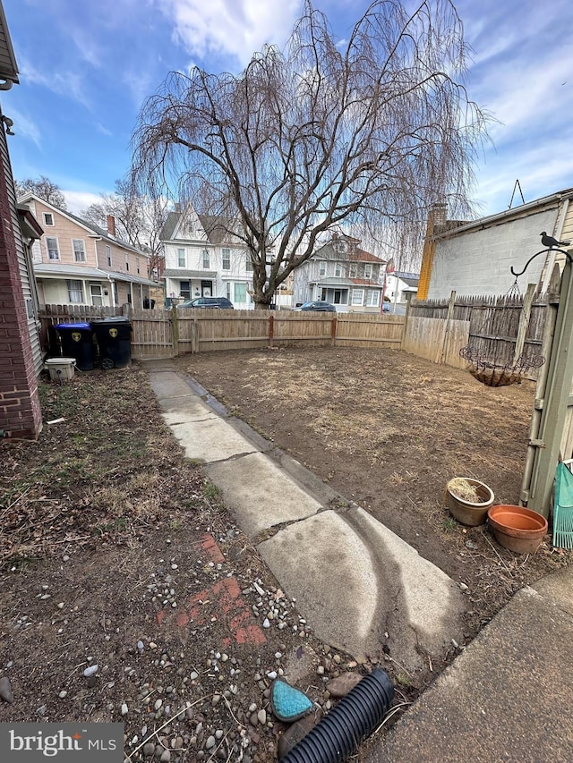 view of yard with a residential view and fence