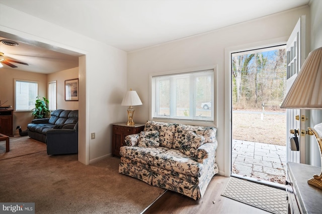 living area featuring visible vents and ceiling fan