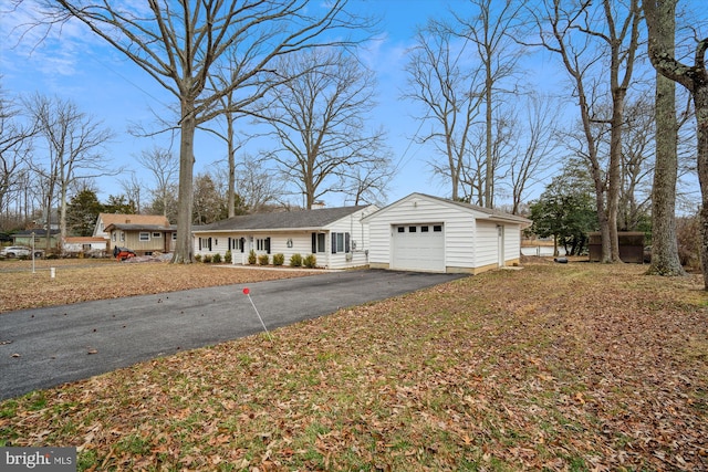 ranch-style house featuring driveway and an attached garage