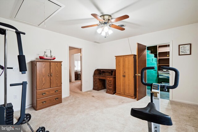 workout area featuring light carpet, attic access, visible vents, and baseboards