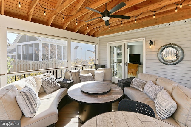 sunroom featuring lofted ceiling with beams, wood ceiling, and a ceiling fan