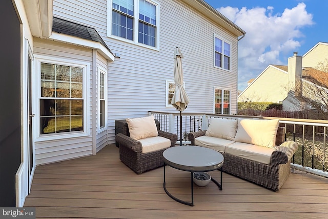 wooden deck with fence and an outdoor living space