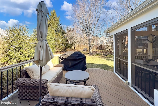 deck with a sunroom, fence, grilling area, and an outdoor hangout area