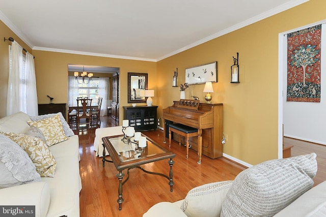 living area featuring crown molding, wood finished floors, and an inviting chandelier