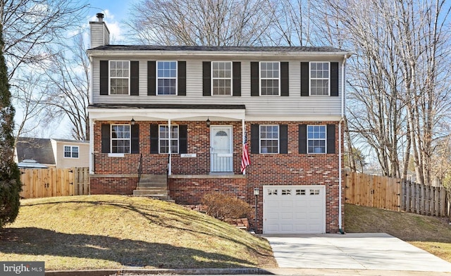 colonial home with a garage, brick siding, fence, driveway, and a chimney