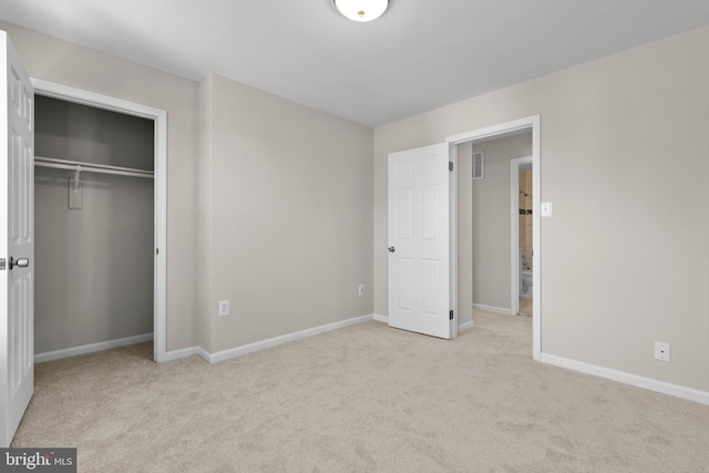 unfurnished bedroom featuring a closet, carpet, visible vents, and baseboards