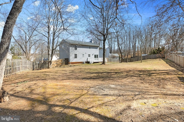 view of yard with a deck and a fenced backyard