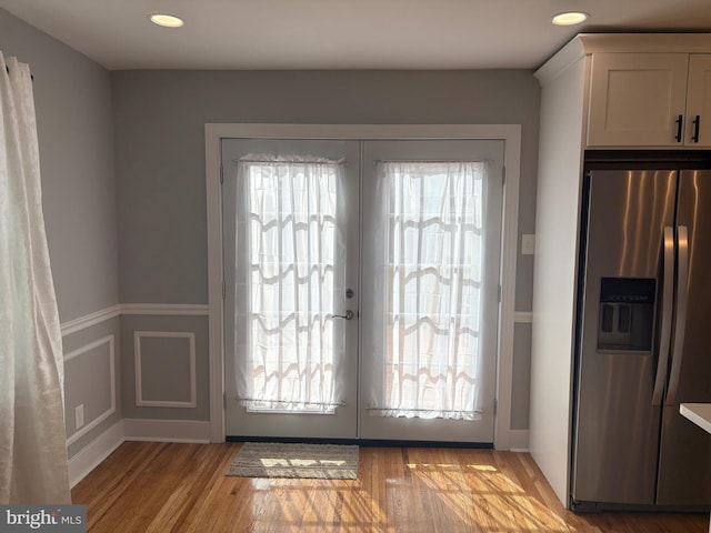 doorway with light wood-type flooring, french doors, and recessed lighting