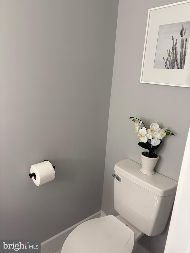 bathroom with toilet and baseboards